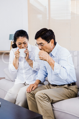 Couple enjoying drinks on the couch