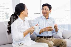 Couple enjoying coffee on the couch