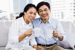 Potrait of couple enjoying coffee on the couch