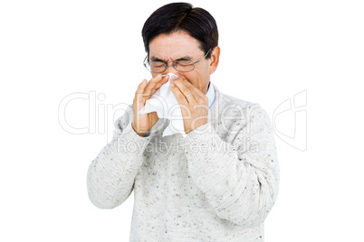 Smiling man using a tissue