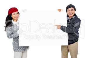 Portrait of couple with blank cardboard