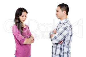 Upset couple standing with arms crossed