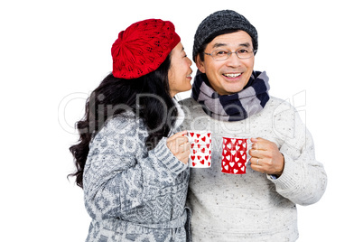 Older asian couple having hot drinks