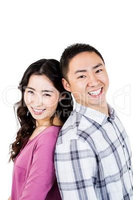 Smiling asian couple looking at camera