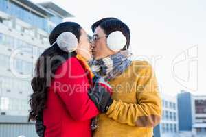 Older asian couple kissing on balcony