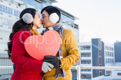 Older asian couple showing a heart