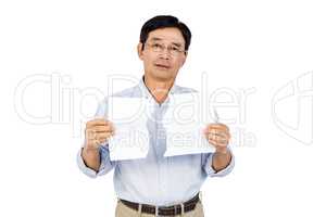 Older asian man showing ripped page