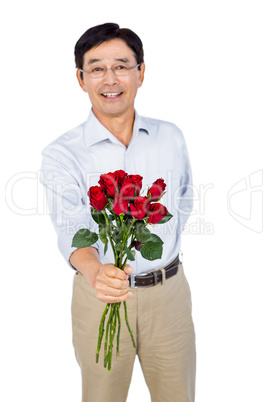 Older asian man offering roses