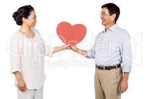 Older asian couple holding heart