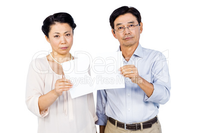 Couple holding torn paper