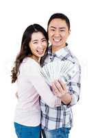 Portrait of smiling couple holding money