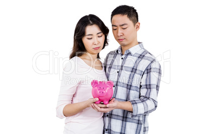 Couple holding their piggy bank