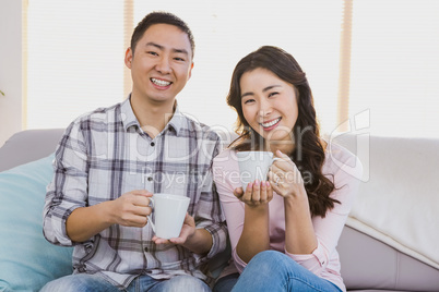 Portrait of happy couple holding coffee cup