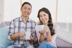Portrait of happy couple holding coffee cup