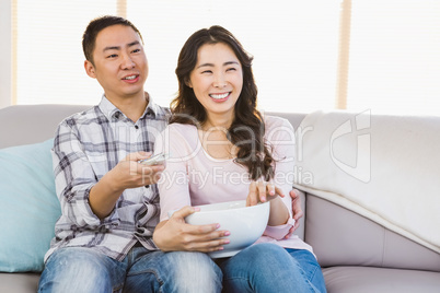 Happy couple sitting on sofa a