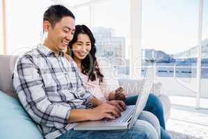 Young couple using laptop