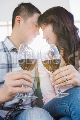 Low angle view of couple holding wineglasses