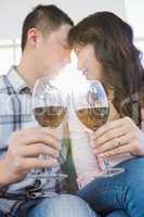 Low angle view of couple holding wineglasses