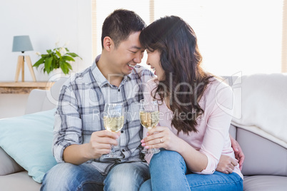 Young smiling couple drinking wine