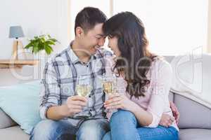 Young smiling couple drinking wine