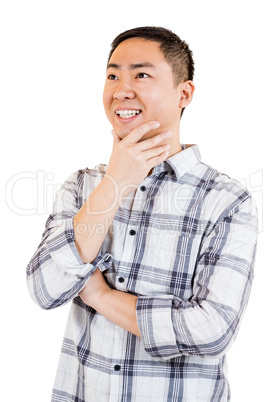 Happy young man with hand on chin