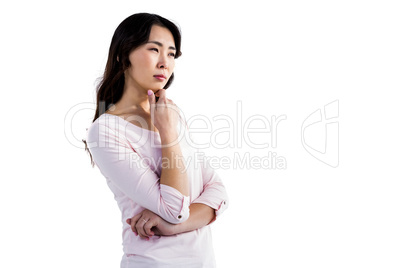 Thoughtful young woman with hand on chin