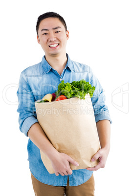 Portrait of man with grocery bag