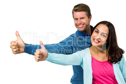 Portrait of smiling couple showing thumps up sign