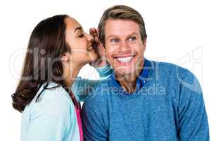 Woman sharing secret with man