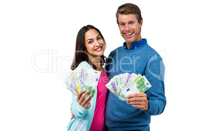 Portrait of couple showing money