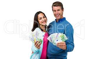 Portrait of couple showing money