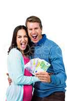 Excited couple holding money