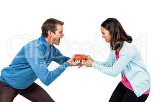 Man and woman holding model house