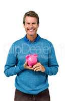 Portrait of smiling man holding piggy bank