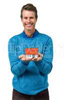 Portrait of smiling man holding model house