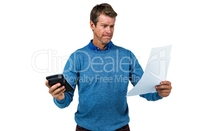 Shocked man holding calculator and paper