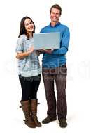 Portrait of smiling couple holding laptop