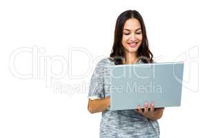 Smiling woman using laptop