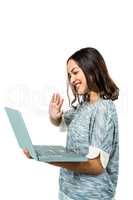 Smiling woman gesturing while holding laptop