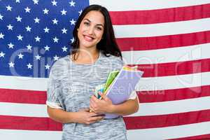 Portrait of smiling woman standing against American flag