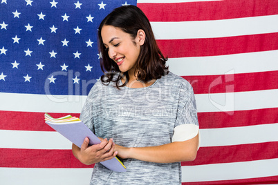 Smiling woman standing against American flag