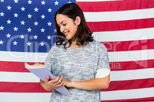 Smiling woman standing against American flag