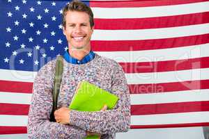 Smiling man standing against American flag