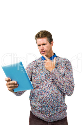 Close-up of confused man reading book