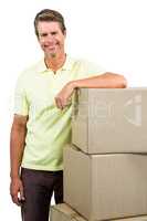 Smiling man standing by boxes