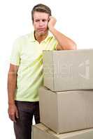 Sad man standing by with boxes