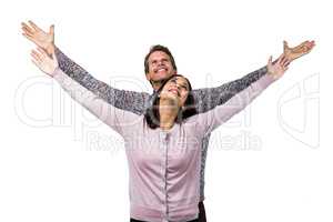 Smiling couple with arms raised