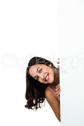 Portrait of smiling woman behind board Portrait of smiling woman behind board