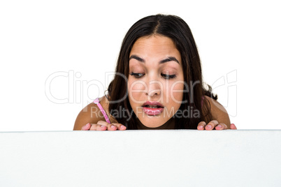 Woman peeking against white background