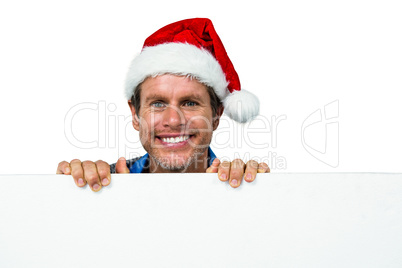 Portrait of smiling man wearing Santa hat Portrait of smiling man wearing Santa hat